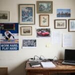 A sleek 2026 modern home office setup showcasing the ultimate workspace aesthetic trend: a large custom milestone wall art canvas hanging above a minimalist desk, replacing generic stock art with personalized solopreneur achievements.